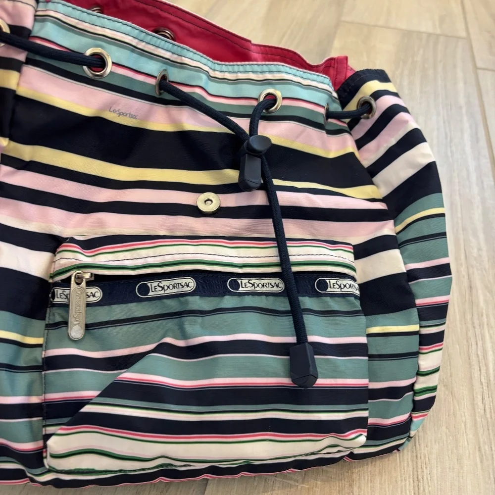 LeSportsac Voyager drawstring backpack in a navy pastel stripe pattern.